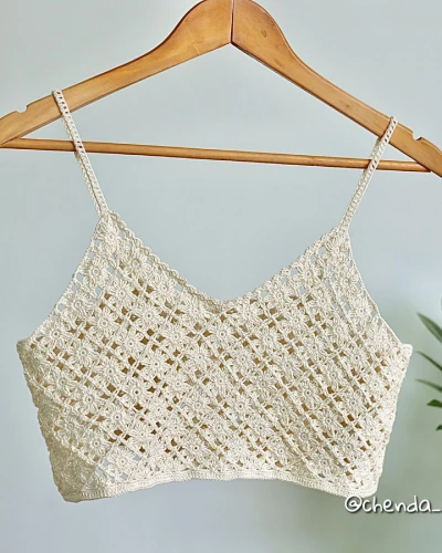 Back view of crochet floral square top showing floral motifs and scalloped hem.