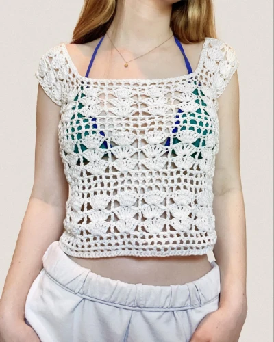 Front view of summer crochet stitch top with shell motif, cropped fit, and wide short sleeves.