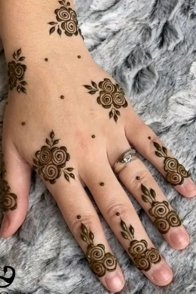 Elegant floral mehndi design with layered flowers, curved vines, and ornamental henna details.