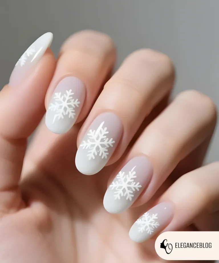 Winter nail design featuring two nails decorated with delicate snowflake details.