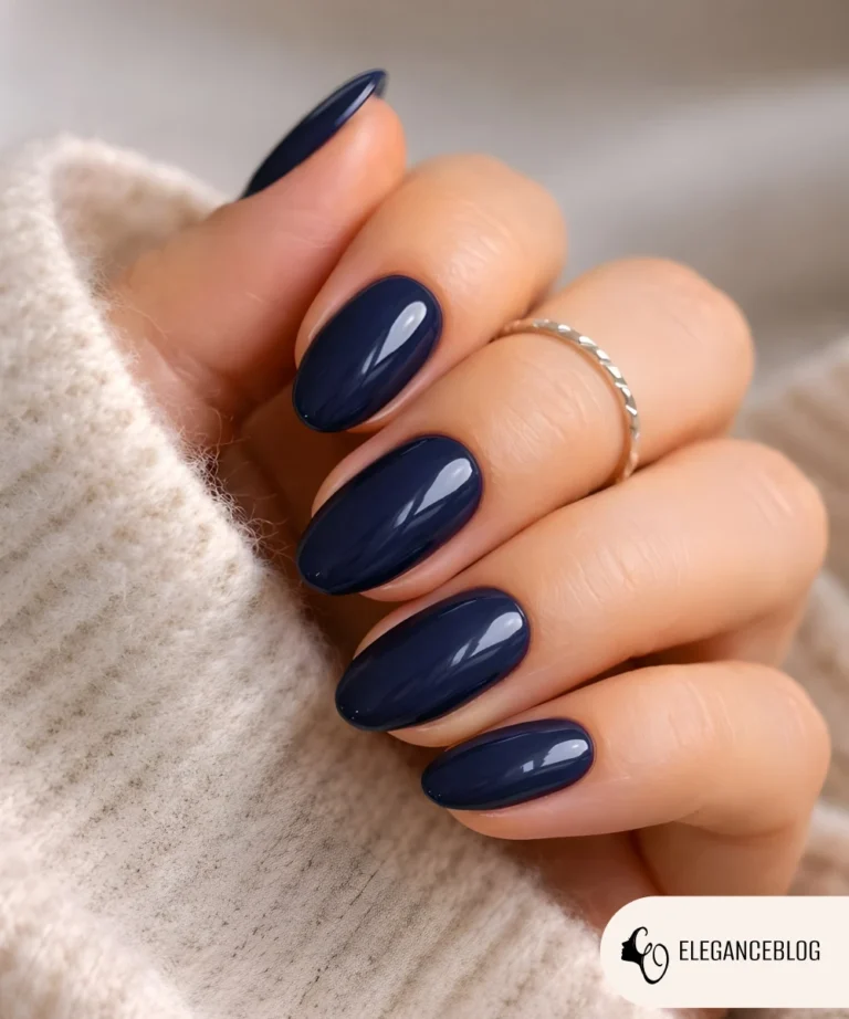Midnight navy gel nails on almond-shaped fingers for winter