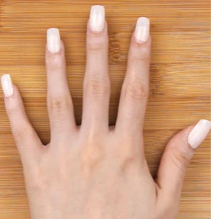 Close-up of nails being filed during a professional manicure