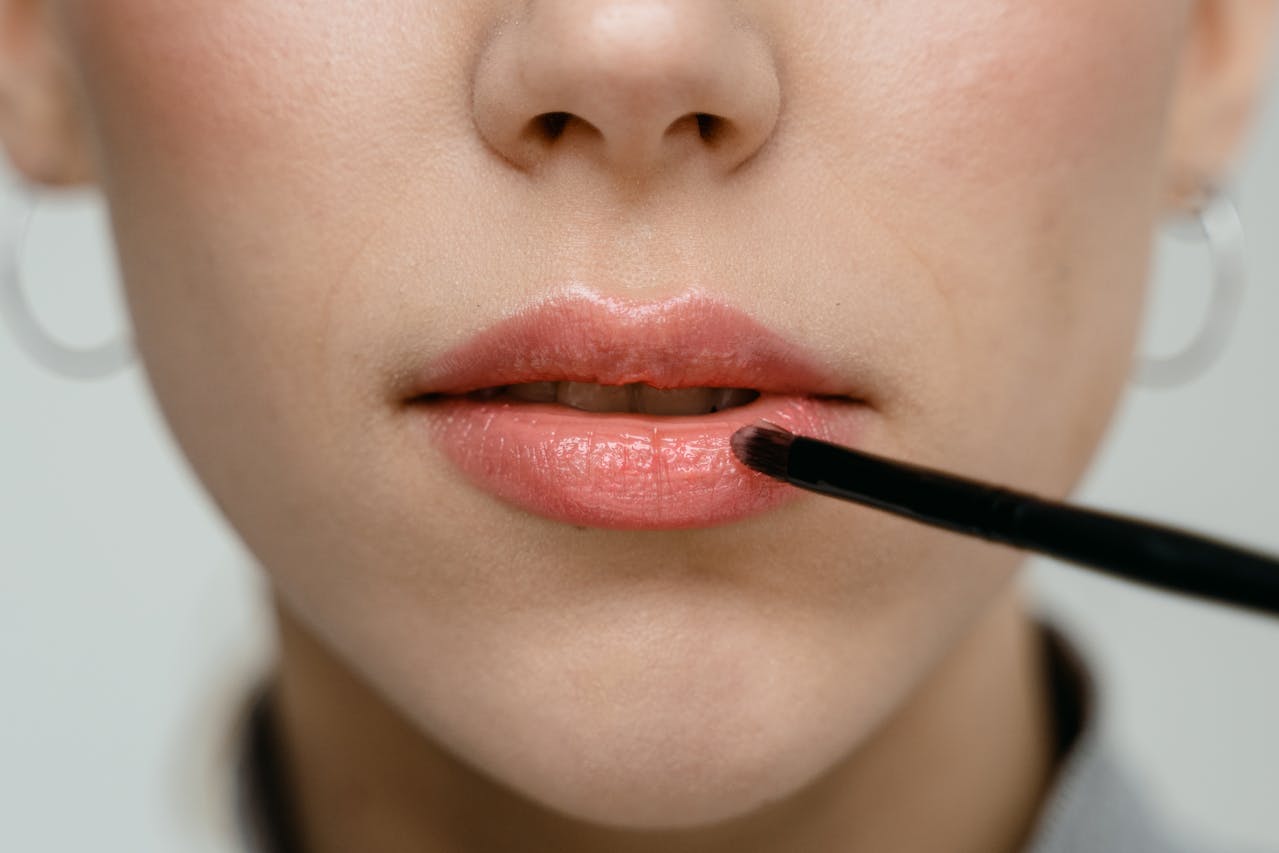 woman styling lips